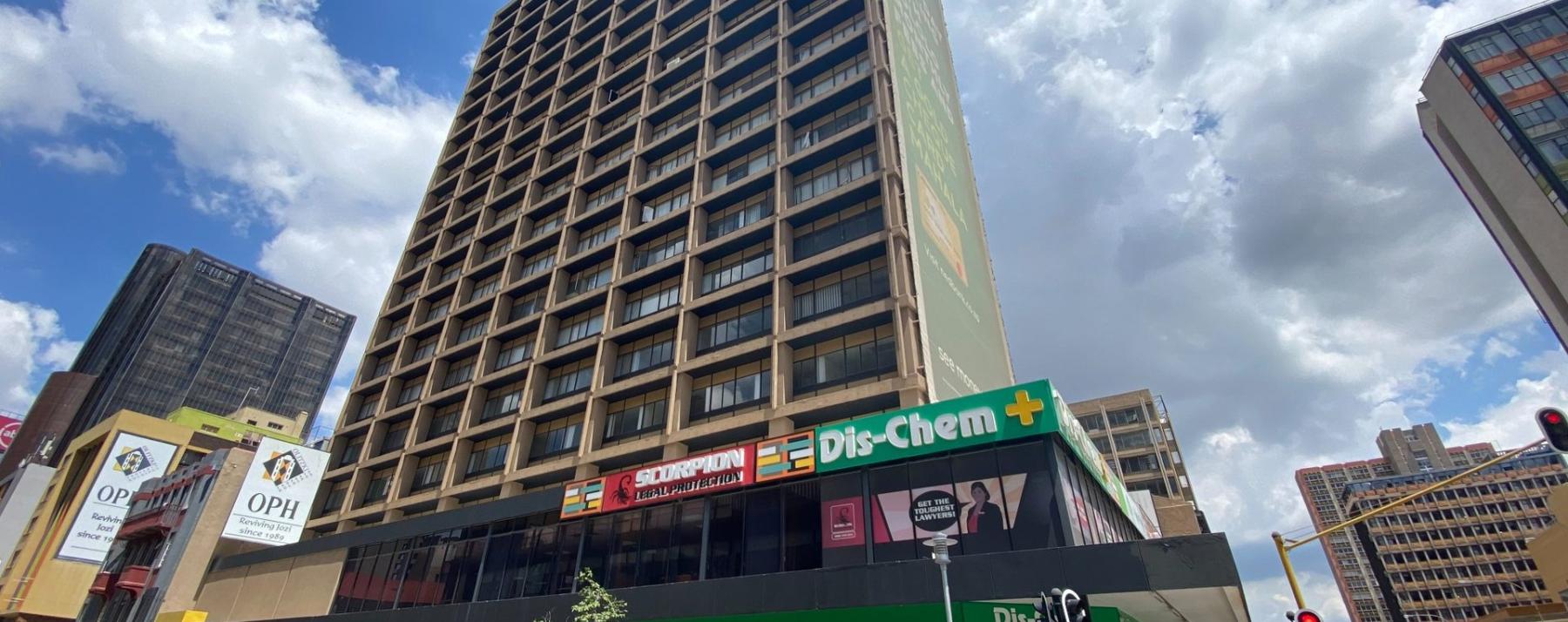 Modern high-rise office building with Dis-Chem and Scorpion signage